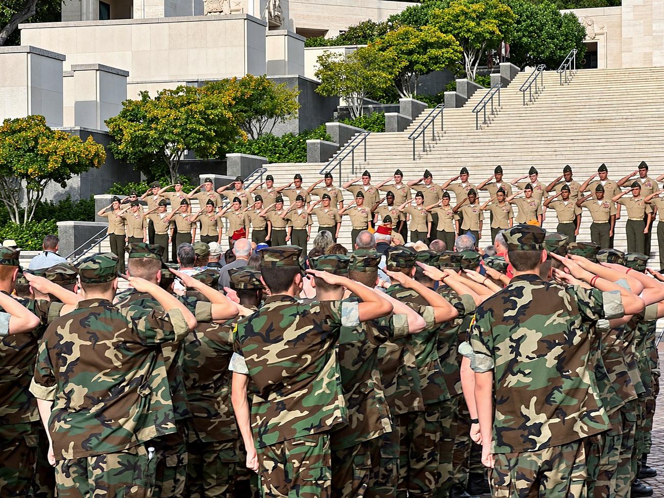 Young Marines saluting during a ceremony on the steps at the National Memorial Cemetery of the Pacific