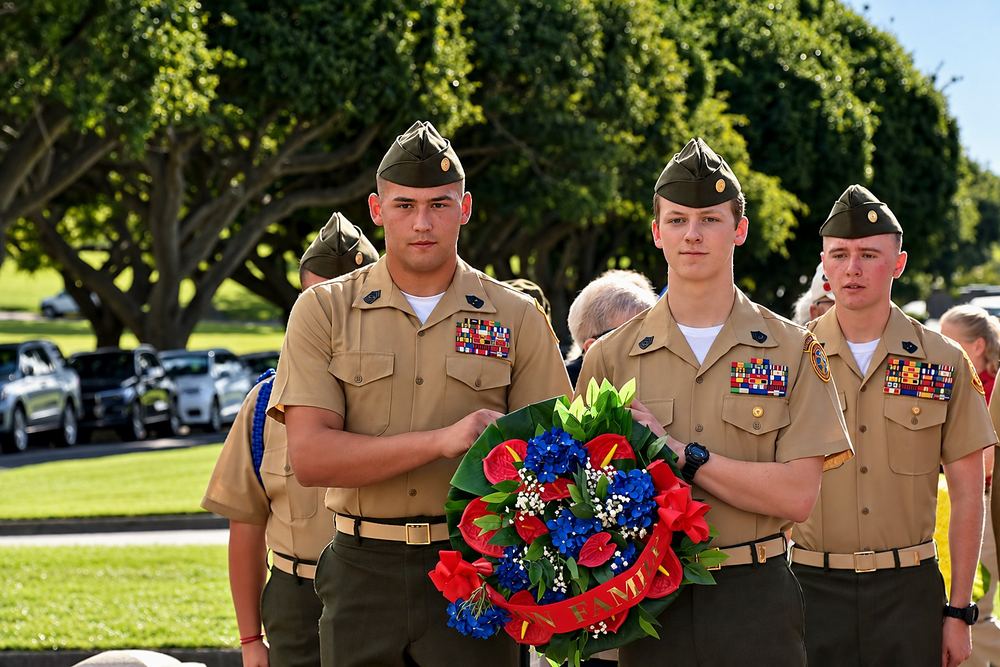 Young Marines in service uniform carrying a memorial wreath